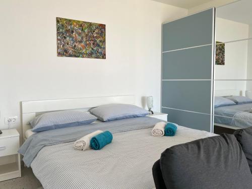 a bedroom with two beds with towels on the bed at Studio Apartment Ravel in Ičići