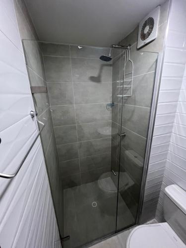 a shower with a glass door in a bathroom at Manglar - Ciudad Mallorquin in Puerto Colombia