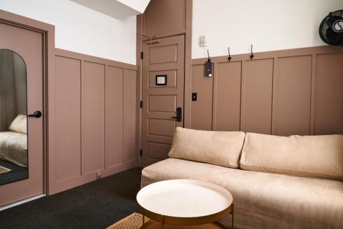 a living room with a couch and a table at The Society Hotel in Portland