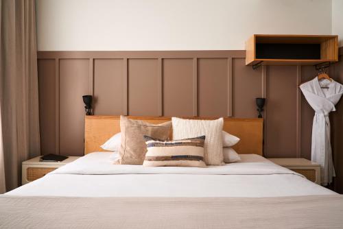 a bedroom with a large white bed with pillows at The Society Hotel in Portland