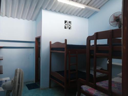 a room with two bunk beds and a window at Hostal Aruba in Atacames