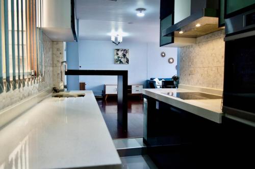 a kitchen with a white counter and a sink at Cozy & Modern apartment in Arequipa!! in Arequipa