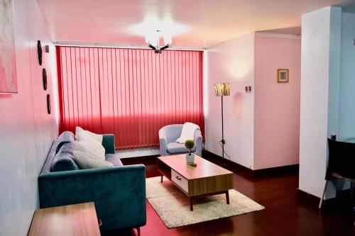 a living room with a blue couch and a table at Cozy & Modern apartment in Arequipa!! in Arequipa