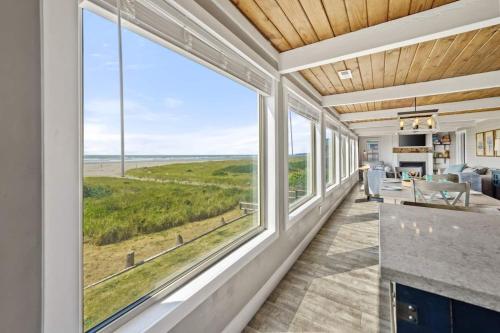 a living room with large windows and a view of the ocean at Tide Pool Town Home, Entire House, Amazing Views! in Moclips