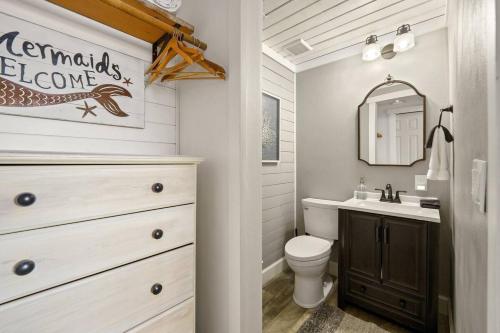 a bathroom with a sink and a toilet and a mirror at Tide Pool Town Home, Entire House, Amazing Views! in Moclips