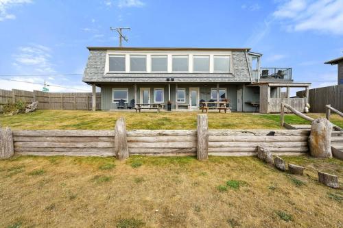 a house with a fence in front of it at Tide Pool Town Home, Entire House, Amazing Views! in Moclips