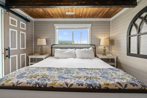 a bedroom with a bed and two tables with lamps at Tide Pool Town Home, Entire House, Amazing Views! in Moclips