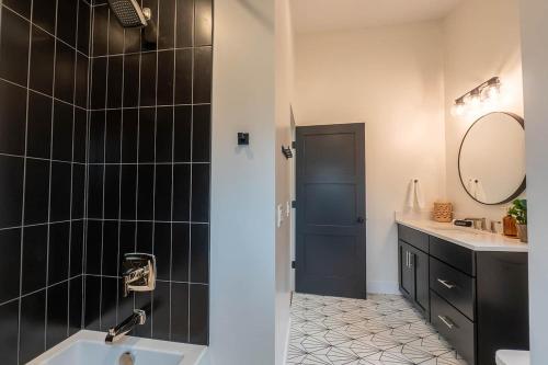 a bathroom with a sink and a mirror at Michigan Mod Walk To Downtown in Saugatuck