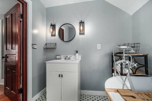 a bathroom with a white sink and a mirror at Relaxing Ski & Soak Getaway in Benzonia