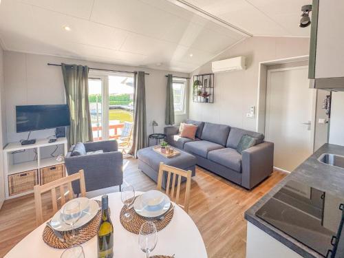 a living room with a couch and a table at Fuut 24-26 in Nieuwersluis