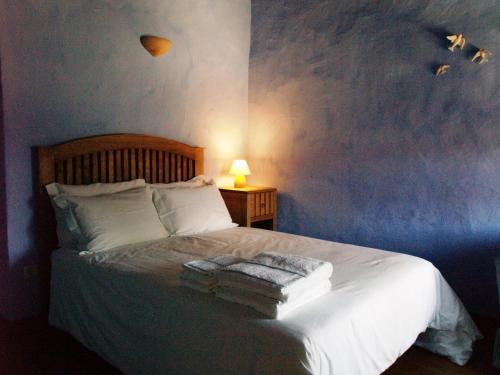 En eller flere senge i et værelse på Casa da Ti Cura