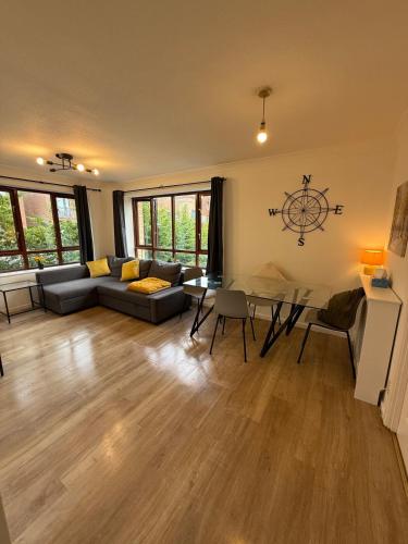a living room with a couch and a table at Milton keynes city stay in Milton Keynes
