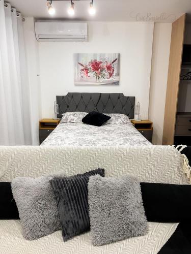 a bedroom with a bed with two pillows on it at Skylux Studios de Luxo in Rio de Janeiro