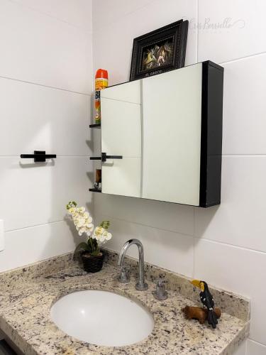 a bathroom counter with a sink and a cupboard at Skylux Studios de Luxo in Rio de Janeiro