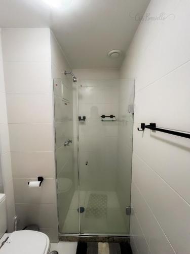 a bathroom with a glass shower with a toilet at Skylux Studios de Luxo in Rio de Janeiro