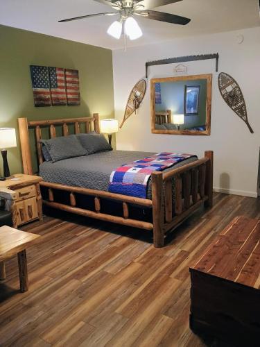 a bedroom with a wooden bed and a mirror at Wild Mountain Lodge in Sevierville