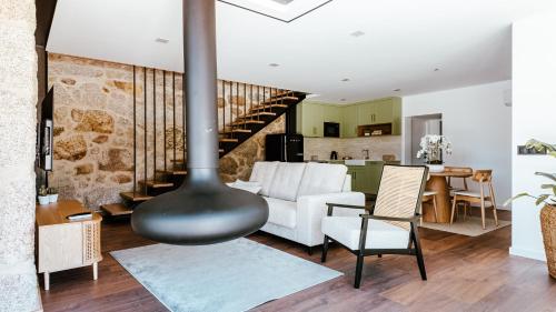 a living room with a wood stove in the middle at Refugio das Poldras-Villa 63 in Mondim de Basto