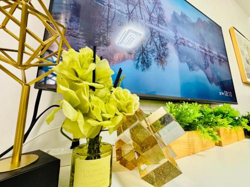 a vase filled with yellow flowers on a table at Mesavirre Garden Residences - Skybox Living in Bacolod