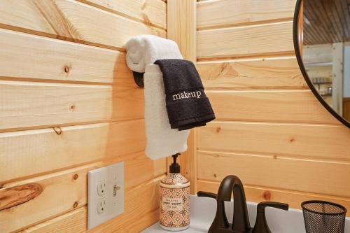 a bathroom with a sink and a towel hanging on a wall at Near Attractionsgame Roomsecludedgives Back! in Laurelville