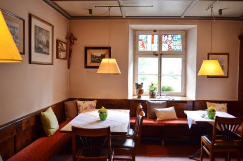 a dining room with two tables and a window at Alte Post - Hotel Am Rhein-Ufer Laufenburg in Laufenburg