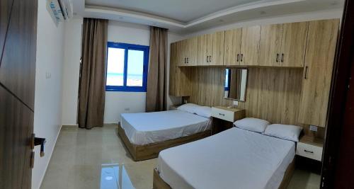 a hotel room with two beds and a window at isis MARINA in Hurghada