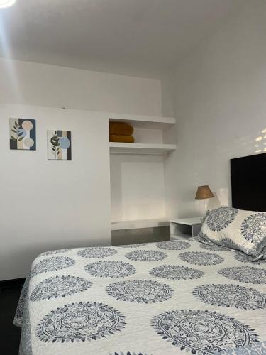 a bedroom with a bed with a white bedspread at Complejo Semaso in Santa Rosa