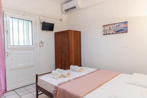 a small bedroom with a bed and a window at Apartment's Theodoros in Kamena Vourla