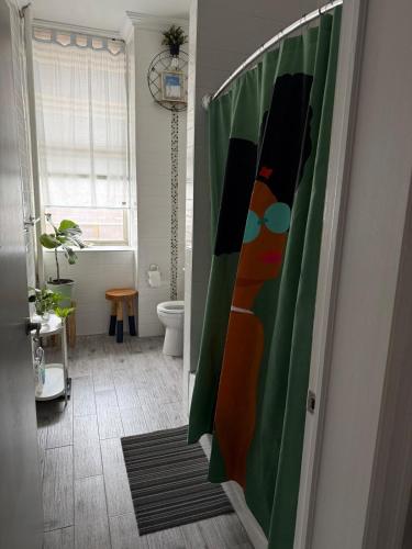a bathroom with a painting of a woman on the door at Central Park north spacious residence in New York