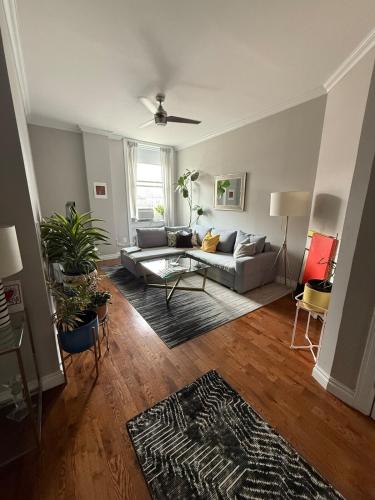 a living room with a couch and a table at Central Park north spacious residence in New York
