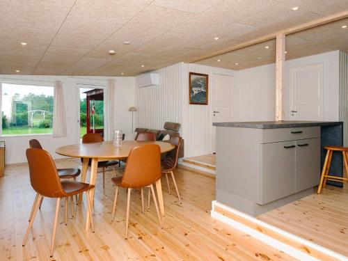 a kitchen and dining room with a table and chairs at 6 person holiday home in Ebeltoft in Ebeltoft