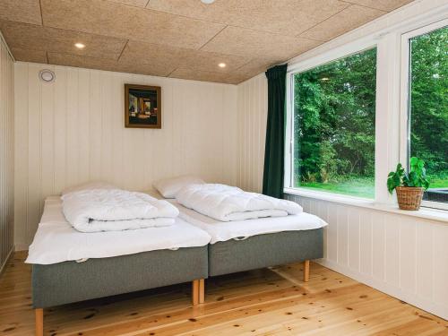 a bed in a room with a window at 6 person holiday home in Ebeltoft in Ebeltoft