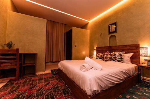 a bedroom with a large bed with pillows on it at Nour Mogador in Ghazoua