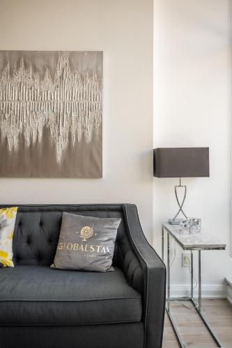 a living room with a black couch and a table at Gorgeous 1 Bedroom Apt with Balcony in Yorkville in Toronto