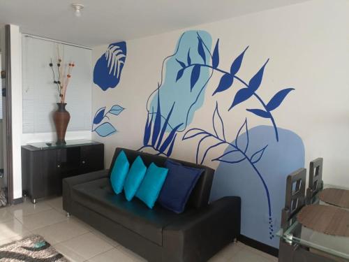 a living room with a couch and a blue mural at Apartamentos con piscina en zona turistica in Montenegro