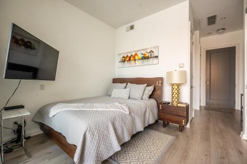 a bedroom with a bed and a flat screen tv at Gorgeous 1 Bedroom Apt with Balcony in Yorkville in Toronto