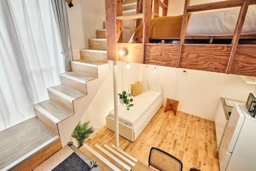 a small room with stairs and a bed in it at KJ Hotel in Musashino