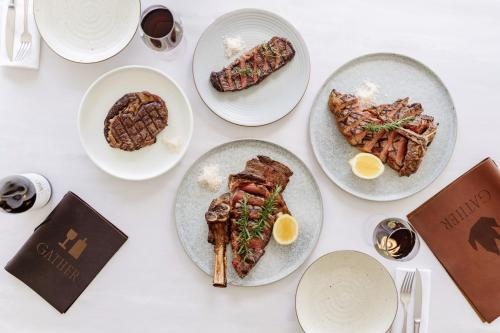 a white table with plates of food on it at Rydges Resort Hunter Valley in Lovedale