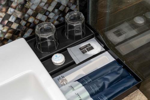 a drawer with two cups and a sink in a room at VanHao Serviced Apartment-Zhujiang Newtown-Near the US consulate-Vaperse the same building in Guangzhou