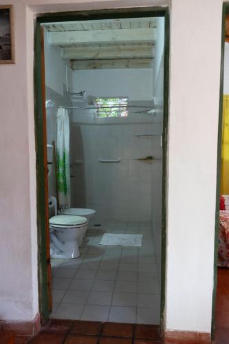 a bathroom with a toilet in a room at Quincho Don Mario in Bella Vista