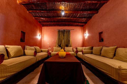 a living room with couches and a table at Nour Mogador in Ghazoua