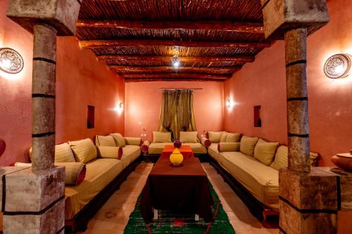 a living room with a couch and a table at Nour Mogador in Ghazoua