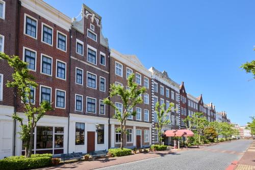 a large red brick building on a street at Hotel Amsterdam Huis Ten Bosch in Sasebo