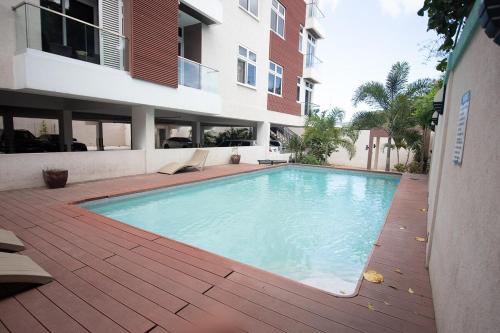 a swimming pool in front of a building at Sierra Vista - Liguanea Kingston 6 -Near US Embassy in Kingston