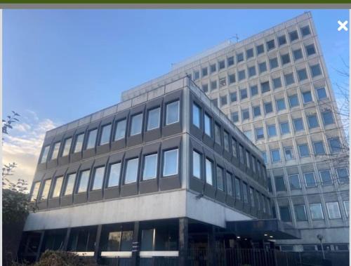 a large office building with a lot of windows at City Views Top Floor - Bradford City Center in Bradford