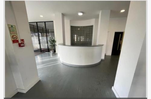 a large lobby with a large white building at City Views Top Floor - Bradford City Center in Bradford