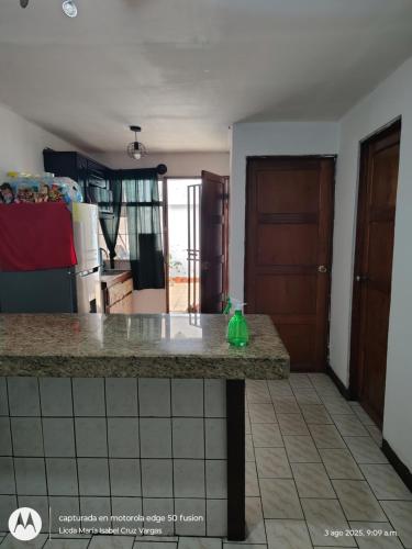 a kitchen with a counter top in a room at Lidia's House in Alajuela City