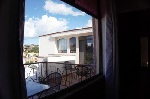 a view from a window of a balcony with chairs at Hotel del Centro in Bernal