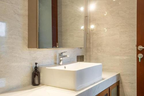 a bathroom with a white sink and a mirror at Modern 5BR Luxury Villa with Pool & Rooftop - 100m from Sanur Beach in Sanur