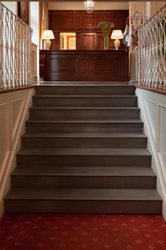 a staircase in a house with a red carpet at Hotel Executive in Florence