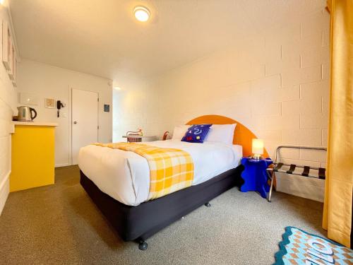 a bedroom with a large bed in a room at Mount Eden Motel in Auckland